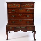 A George III mahogany chest on stand, the mahogany top above two short and three long drawers raised