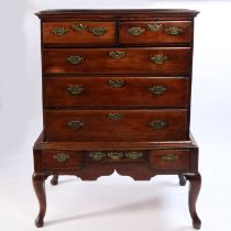 A George III mahogany chest on stand, the mahogany top above two short and three long drawers raised