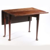 A George III mahogany drop leaf dining table, the rectangular top above tapering legs and pad