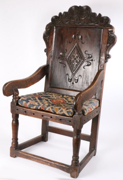 A 17th Century and later oak wainscot, Yorkshire, with a scroll carved arching crest above a diamond - Image 2 of 4