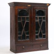 A George III mahogany hanging bookcase/display cabinet, the concave cornice above astragal glazed