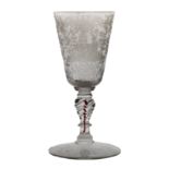 An 18th Century Bohemian engraved goblet, with engraved decoration showing figures among swags, a