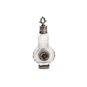 A good 17th Century clear crystal perfume bottle, circa 1680, with silver mounts, 9cm high See