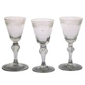 Three 18th Century Bohemian wine glasses, circa 1725-1750, with foliate engraved decoration above