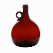 A mid 19th Century English brown glass wine flagon, circa 1840, with loop handle, 19cm tall