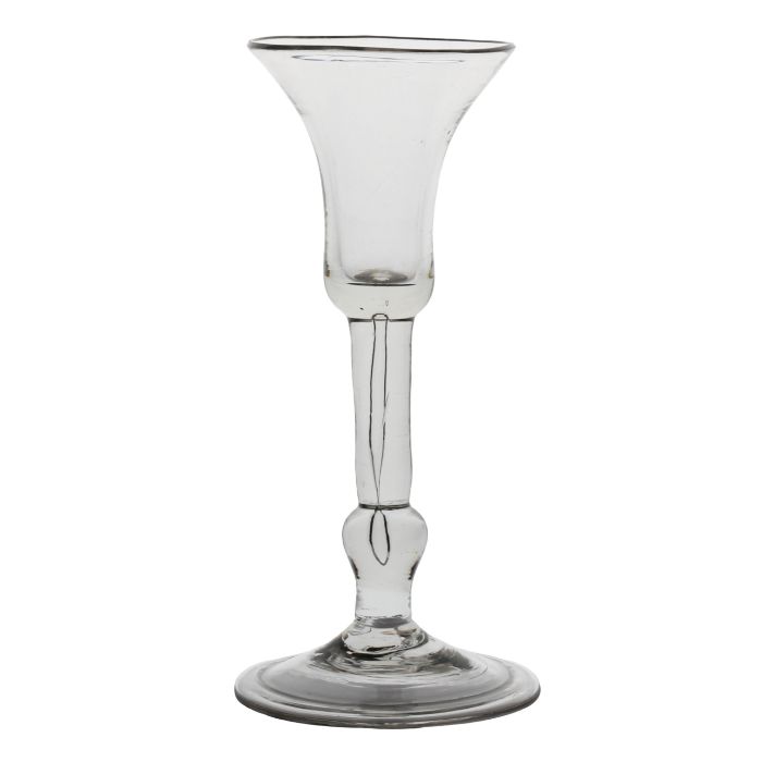 A mid 18th Century baluster wine glass, English circa 1730, the bell bowl with a long tear to the