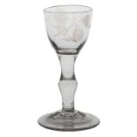 A mid 18th Century small baluster wine glass, the ovoid bowl engraved with rosebud above the swollen