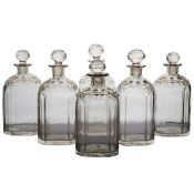 A set of six early 19th Century spirit decanters, with gilt flowers to the necks and facetted