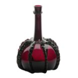An 18th Century amethyst glass decanter, of bottle form with a long tapering neck issuing from a