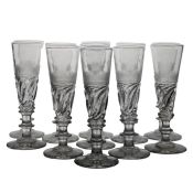 A set of early 19th Century French Le Creusot wine flutes, circa 1810-20, wrythen base to the