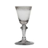 An 18th Century Bohemian wine glass, circa 1725-1750, inverted baluster stem with engraved rococo