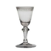 An 18th Century Bohemian wine glass, circa 1725-1750, inverted baluster stem with engraved rococo