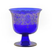 A late 19th Century Murano glass footed bowl, gilded in the Renaissance taste, with a deep blue bowl