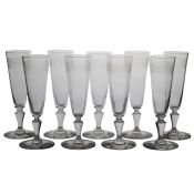A set of nine late19th Century champagne flutes, circa 1880, with inverted baluster stems and etched