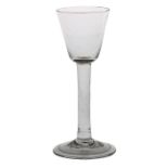 A mid 18th Century wine glass, English circa 1740, rounded bowl with plain stem and folded foot,