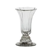 An 18th Century helmet foot syllabub glass, circa 1760, with a ribbed body and helmet foot, the