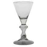 An 18th Century large and heavy baluster goblet, English circa 1700, with a funnel bowl