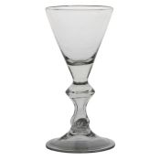 An 18th Century large and heavy baluster goblet, English circa 1700, with a funnel bowl