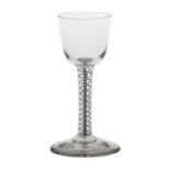 An 18th Century double series opaque twist wine glass, with a wide funnel bowl and central solid