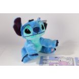 A collection of Stitch toys to include colouring in book soft toy etc We would like to thank