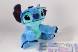 A collection of Stitch toys to include colouring in book soft toy etc We would like to thank