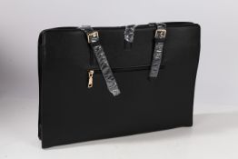 A Igolumon handbag style laptop bag, made from PU leather which is waterproof and having a large