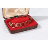 A 9 carat gold gate link bracelet, having a heart shaped locket, weight 7.1 grams, housed within a