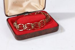 A 9 carat gold gate link bracelet, having a heart shaped locket, weight 7.1 grams, housed within a