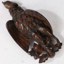 A 19TH CENTURY CARVED OAK GAME BIRD.