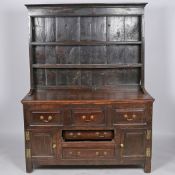 A 18TH CENTURY AND LATER OAK DRESSER AND RACK.