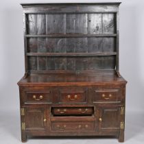 A 18TH CENTURY AND LATER OAK DRESSER AND RACK.