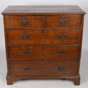 A GEORGE III OAK CHEST OF TWO SHORT AND THREE LONG GRADUATED DRAWERS.