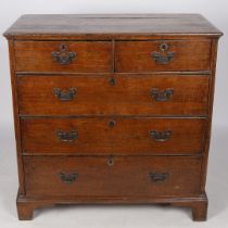 A GEORGE III OAK CHEST OF TWO SHORT AND THREE LONG GRADUATED DRAWERS.