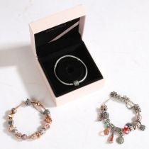 THREE PANDORA CHARM BRACELETS.