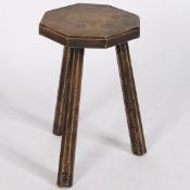 A 19TH CENTURY PRIMITIVE OAK MILKING STOOL.