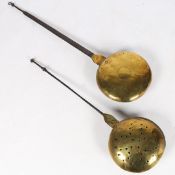 A 17TH CENTURY BRASS WARMING PAN.