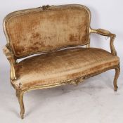 A 19TH CENTURY FRENCH GILDED SALOON SETTEE.