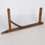 A 20TH CENTURY OAK HANGING SADDLE RACK.