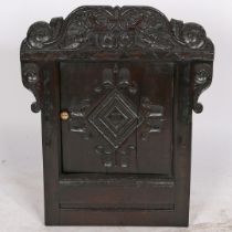 A HANGING CORNER CUPBOARD FORMED FROM A 17TH CENTURY OAK WAINSCOT CHAIR BACK.