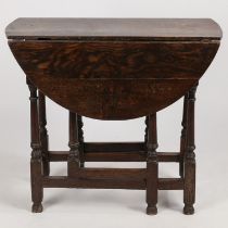 A SMALL OAK DROP LEAF TABLE.