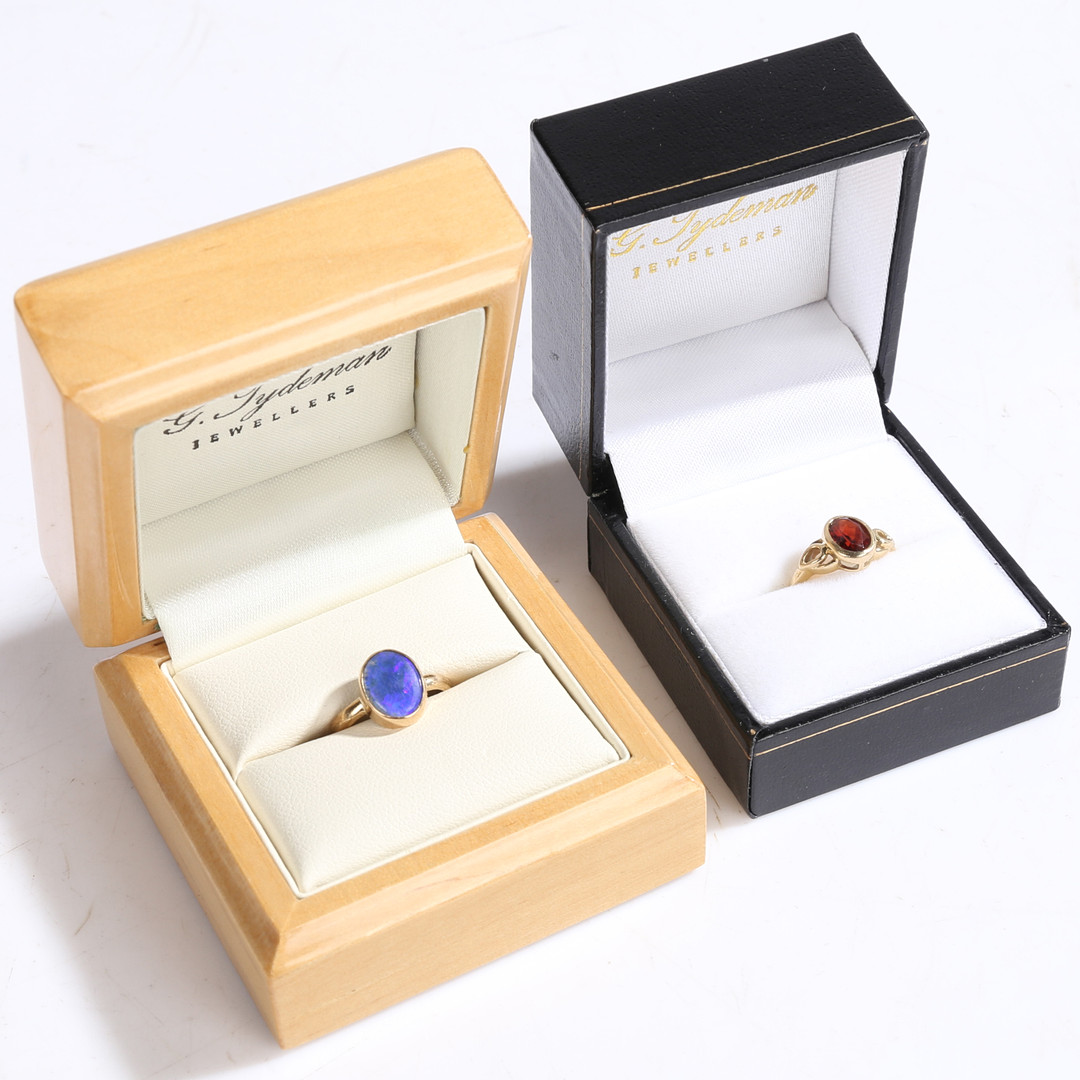 A 9 CARAT GOLD AND GARNET RING, A 9 CARAT GOLD AND OPAL RING (2).