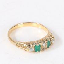 A YELLOW METAL, EMERALD AND DIAMOND RING.
