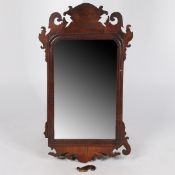 A GEORGE III FRET CARVED MAHOGANY MIRROR.