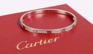 A Cartier 18 carat white gold and diamond love bangle, size 16, the bangle with twelve panels each