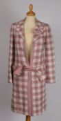 A Chanel Bouclé pink tweed long jacket with camellia flower to the collar, size 34.