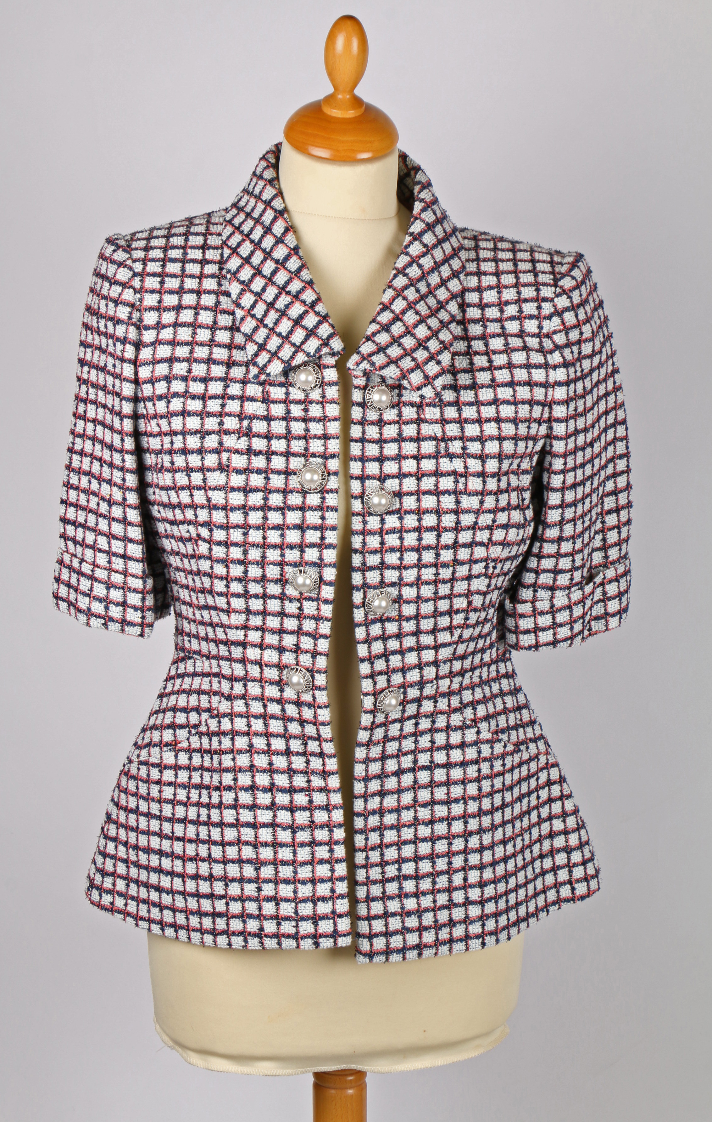 A Chanel short sleeved checked tweed jacket with simulated pearl buttons, size 34.