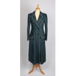 A Chanel forest green bouclé wool coat with bronze metallic trim and simulated amethyst buttons,