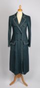 A Chanel forest green bouclé wool coat with bronze metallic trim and simulated amethyst buttons,
