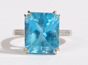 An 18 carat white gold, aquamarine and diamond ring, the head set with a central emerald cut