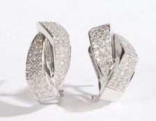 A pair of 18 carat white gold and diamond earrings, each formed from two interlocking angular